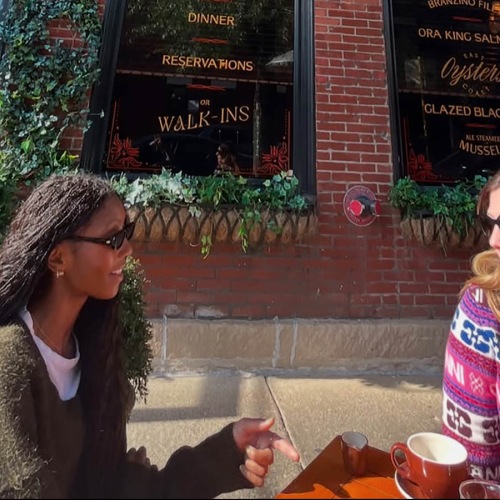 two women dine outside a restaurant
