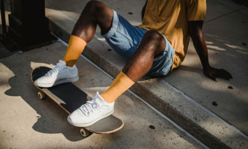 a man's legs on a skateboard