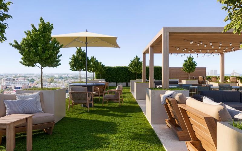 a patio with a table and chairs and a view of the city